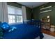 Comfortable bedroom featuring a large window for natural light and wood floors with shelving at 7501 Tipsy Sq, Wake Forest, NC 27587