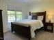 Cozy bedroom with a large window, carpet, and a bedside table with a lamp at 7501 Tipsy Sq, Wake Forest, NC 27587