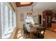 Sunlit dining room showcasing wood table, black chairs, and beautiful backyard view at 7501 Tipsy Sq, Wake Forest, NC 27587
