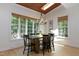 Bright dining room with large windows, a wooden table, and elegant chandelier at 7501 Tipsy Sq, Wake Forest, NC 27587