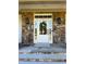 Elegant front door with sidelights, stone accents, and stylish lighting fixtures, creating a welcoming entrance at 7501 Tipsy Sq, Wake Forest, NC 27587