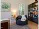 Cozy home office with a comfortable chair, built-in bookshelves, and natural light streaming through the window at 7501 Tipsy Sq, Wake Forest, NC 27587