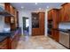 Spacious kitchen boasts a large island, custom cabinets, stone floors, and stainless appliances at 7501 Tipsy Sq, Wake Forest, NC 27587