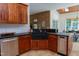 Beautiful kitchen featuring stone countertops, wood cabinetry, and stainless steel appliances at 7501 Tipsy Sq, Wake Forest, NC 27587