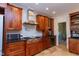 Gourmet kitchen features stone floors, custom cabinets, and high-end Wolf range and stainless vent hood at 7501 Tipsy Sq, Wake Forest, NC 27587