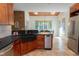 Well-appointed kitchen with a stone sink, wooden cabinets, and access to the dining area at 7501 Tipsy Sq, Wake Forest, NC 27587