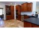 Spacious kitchen with custom wood cabinets, stainless steel appliances, and travertine flooring at 7501 Tipsy Sq, Wake Forest, NC 27587