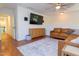 Living room with a tv, comfortable couch, hardwood floors, area rug, and natural light at 7501 Tipsy Sq, Wake Forest, NC 27587