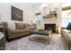 Inviting living room showcasing a stone fireplace, comfortable leather sofa, and a patterned area rug at 7501 Tipsy Sq, Wake Forest, NC 27587