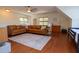Open living room with leather couch, hardwood floors, area rug, and natural light at 7501 Tipsy Sq, Wake Forest, NC 27587