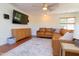 Living room with a tv, comfortable couch, hardwood floors, area rug, and natural light at 7501 Tipsy Sq, Wake Forest, NC 27587