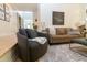 Well-lit living room with stylish furnishings, a patterned rug, and an open floor plan leading to other areas at 7501 Tipsy Sq, Wake Forest, NC 27587