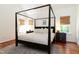 Bright main bedroom with hardwood floors, a rug, and a four-poster bed at 7501 Tipsy Sq, Wake Forest, NC 27587