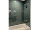 Close-up of a shower featuring green tile and modern fixtures at 7501 Tipsy Sq, Wake Forest, NC 27587