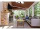 Screened-in porch featuring a fireplace, seating, and view of the backyard at 7501 Tipsy Sq, Wake Forest, NC 27587
