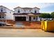 New two-story home under construction featuring Tyvek house wrap, attached garage, and situated in a developing neighborhood at 761 Deschutes Dr, Garner, NC 27529
