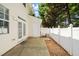 A patio with a white privacy fence and a door that leads into the house at 8253 Martello Ln, Raleigh, NC 27613