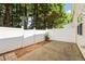 A patio with a white privacy fence and landscaping. It provides a private outdoor space at 8253 Martello Ln, Raleigh, NC 27613