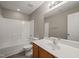 A well-lit bathroom features a shower-tub combo, vanity with sink, and large mirror at 8253 Martello Ln, Raleigh, NC 27613