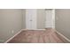 A cozy bedroom with neutral walls and carpet, featuring a closet and access to other rooms at 8253 Martello Ln, Raleigh, NC 27613