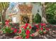 A brick and stone sign with the community logo surrounded by red flowers at 8253 Martello Ln, Raleigh, NC 27613