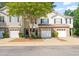Charming townhome with stone accents, attached garage, and mature landscaping at 8253 Martello Ln, Raleigh, NC 27613