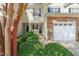 Front of townhome featuring well-maintained landscaping and an attached garage at 8253 Martello Ln, Raleigh, NC 27613