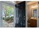 Foyer featuring a half bath off the entryway with wood-look flooring at 8253 Martello Ln, Raleigh, NC 27613