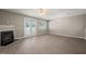 Living room boasting hardwood floors, a ceiling fan, a fireplace, and sliding glass doors for a seamless indoor-outdoor flow at 8253 Martello Ln, Raleigh, NC 27613