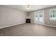 A cozy living room enhanced by hardwood floors, a ceiling fan, a modern fireplace, and sliding glass doors to the outdoors at 8253 Martello Ln, Raleigh, NC 27613