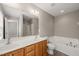 Main bathroom equipped with double sink vanity, a soaking tub, and a separate shower for a luxurious experience at 8253 Martello Ln, Raleigh, NC 27613