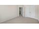 Neutral bedroom with beige carpet, cream walls, and double door closet at 826 Old Tarboro Rd, Wendell, NC 27591