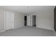 Spacious bedroom with neutral walls, carpet, and three doors at 827 Old Tarboro Rd, Wendell, NC 27591