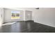 Sun-filled living room with hardwood floors, neutral walls, and view of the landscaped exterior at 827 Old Tarboro Rd, Wendell, NC 27591