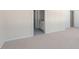Bedroom with neutral carpet, offering access to the bathroom and closet space at 828 Old Tarboro Rd, Wendell, NC 27591