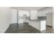 Spacious kitchen featuring an island, white cabinets, stainless steel appliances, and flooring at 828 Old Tarboro Rd, Wendell, NC 27591