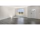 Bright living room features wood floors, a large window, and a white door at 828 Old Tarboro Rd, Wendell, NC 27591