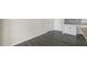 Side view of kitchen with sleek gray flooring and white cabinets, and gray granite countertops at 831 Old Tarboro Rd, Wendell, NC 27591