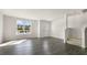 Bright living room with hardwood floors, large window, and staircase at 834 Old Tarboro Rd, Wendell, NC 27591