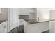 Modern kitchen island featuring granite countertops, stainless steel sink, and white cabinets at 837 Old Tarboro Rd, Wendell, NC 27591