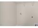 The laundry room is equipped with essential hookups and shelving for streamlined organization and convenience at 837 Old Tarboro Rd, Wendell, NC 27591