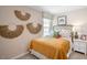 Small bedroom with a cozy bed and decorative wall hangings at 8544 Beckett Chase Way, Raleigh, NC 27616