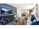 Open-concept living area with hardwood floors, stylish furniture, and large TV perfect for relaxing and entertaining at 8544 Beckett Chase Way, Raleigh, NC 27616