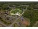 Aerial view of a property surrounded by dense trees in a well-developed neighborhood at 91 Carsons Creek Trl, Wendell, NC 27591