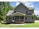 View of the home's backyard showcasing a screened porch and beautiful siding at 91 Carsons Creek Trl, Wendell, NC 27591