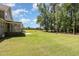 Expansive backyard with lush lawn and mature trees create a private outdoor space at 91 Carsons Creek Trl, Wendell, NC 27591