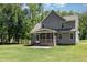 View of the home's backyard showcasing a screened porch and beautiful siding at 91 Carsons Creek Trl, Wendell, NC 27591