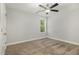 A bedroom features neutral walls, carpeting, and a window with a view to the outdoors at 91 Carsons Creek Trl, Wendell, NC 27591