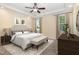A furnished bedroom features a tray ceiling, neutral carpet, a bed and other furnishings at 91 Carsons Creek Trl, Wendell, NC 27591