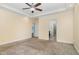 This bedroom has a tray ceiling, neutral carpet, and is connected to a bathroom and closet at 91 Carsons Creek Trl, Wendell, NC 27591